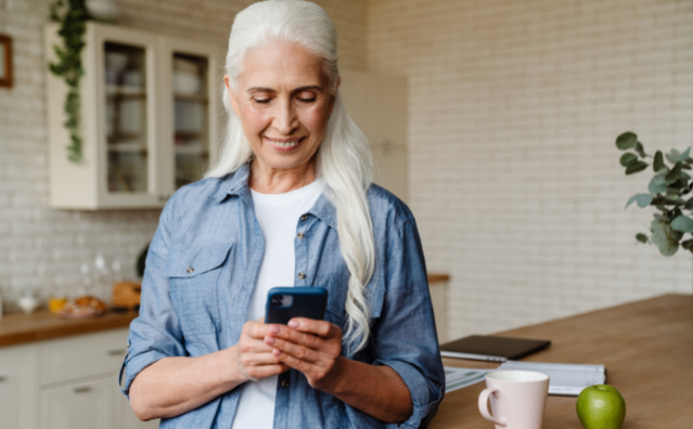 A woman uses her phone to access SD1's Customer Portal 